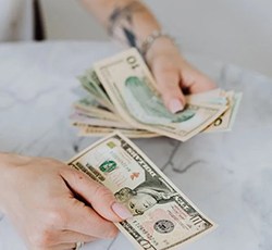 Close up of woman’s hands counting cash