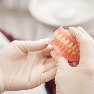 dentist holding dentures
