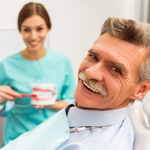 person smiling while visiting dentist